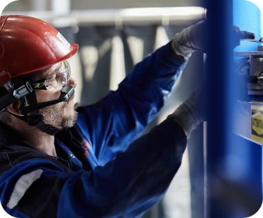 A frontline worker in a RealWear Headset works on some machinery, leveraging Webex Expert on Demand.