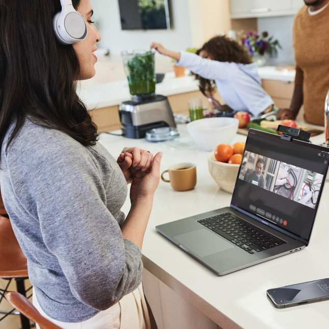 A remote expert works from her kitchen and leverages Expert on Demand to consult with a frontline worker who is on site.