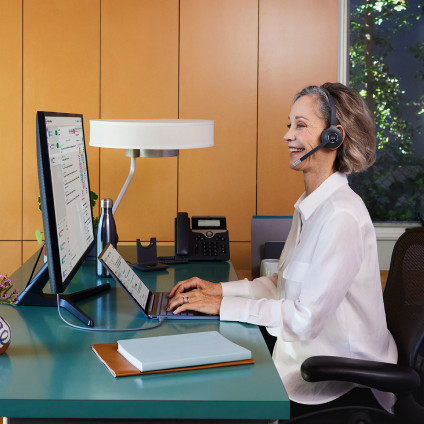 person looking busy and possibly on a call at desk