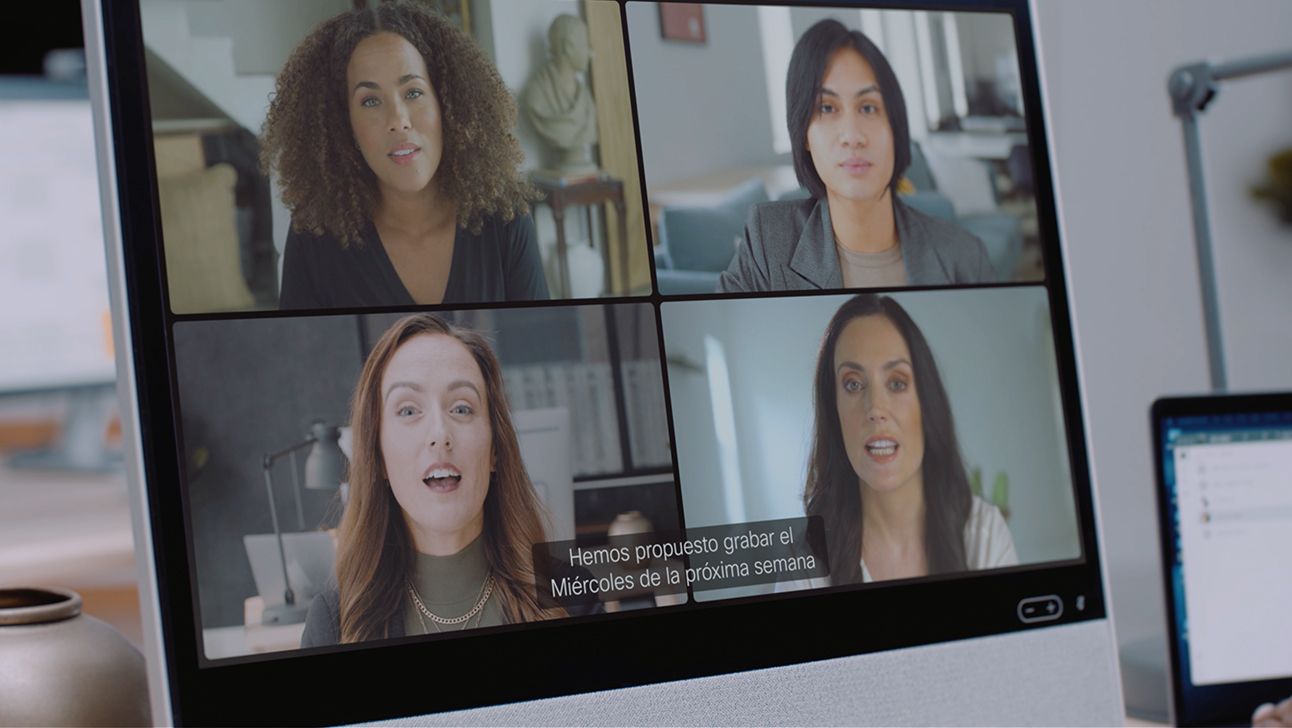 Video conference on Cisco Desk Pro uses real-time translation for Spanish-speaking team members.